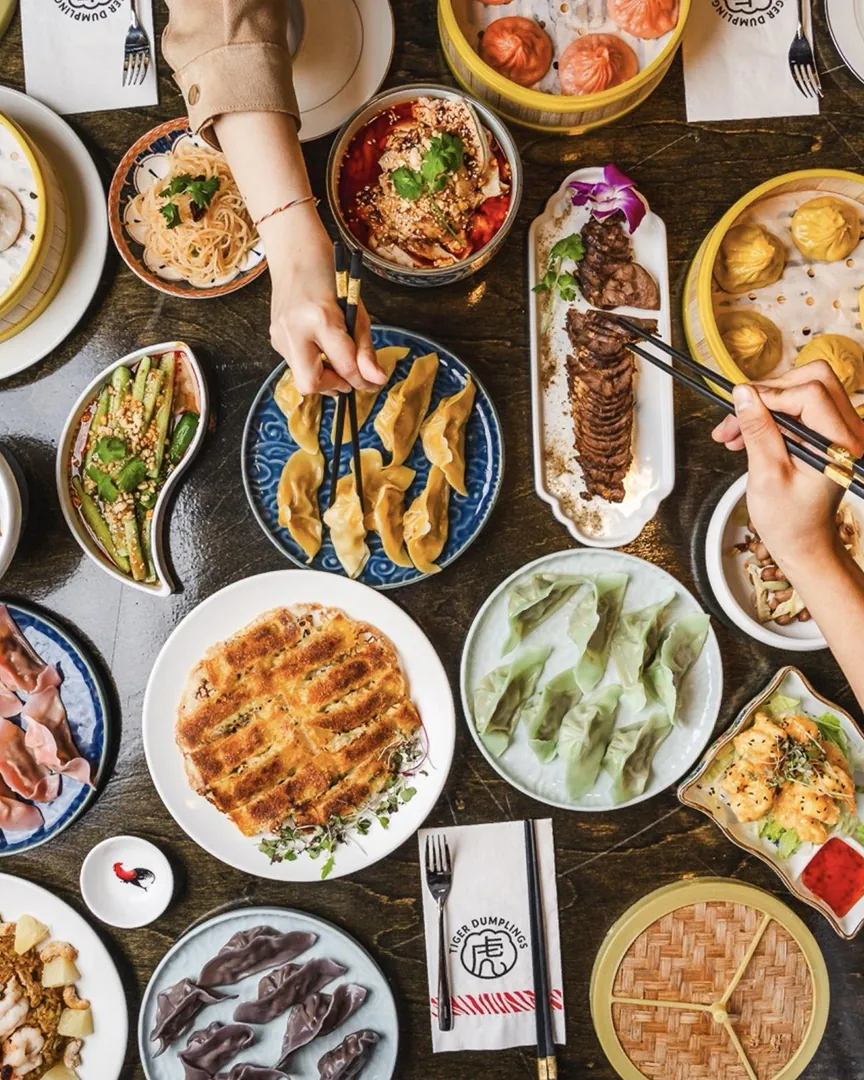 Assorted Asian Dishes on Dining Table at Little Tiger Dumplings，a Asian Restaurant in Washington